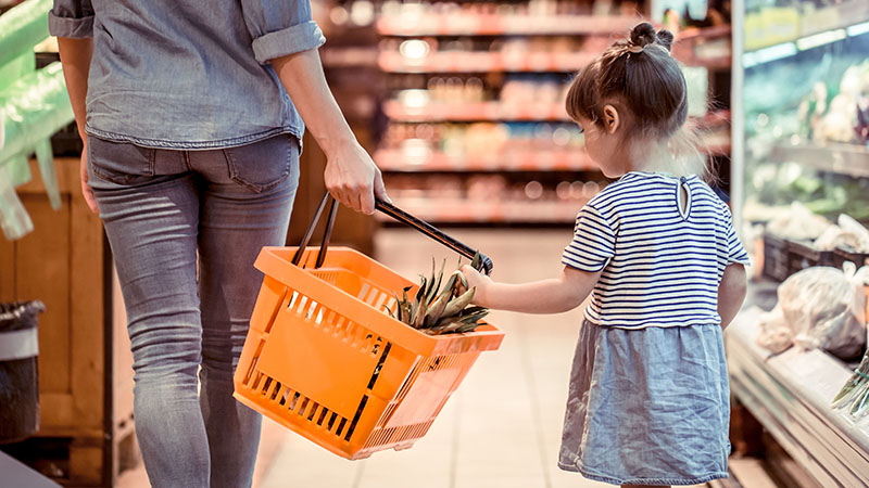 Mom and daughter are shopping at the supermarket